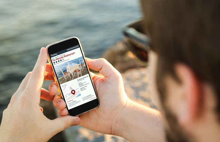 man on phone looking at online directory