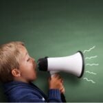 Little Boy Yelling through a megaphone