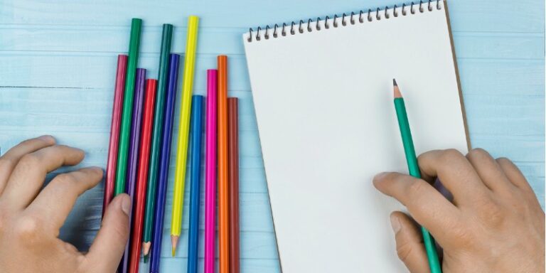 colored pencils and blank white paper