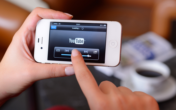 woman watching youtube on cellphone