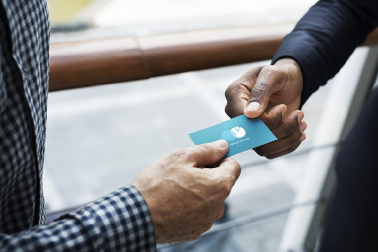 Two people trading business cards