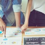 two people looking at colored graphs